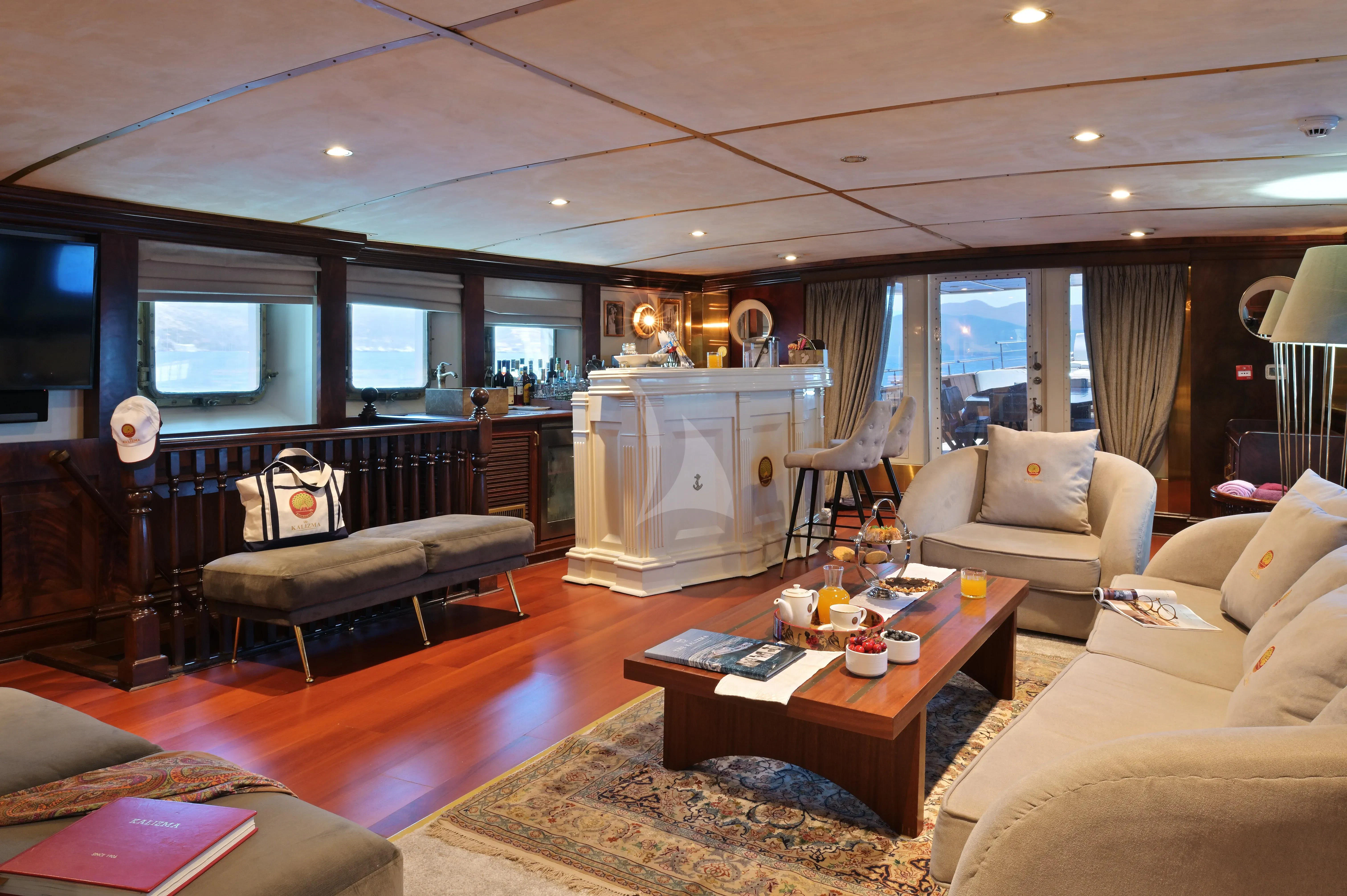 a living room with a fireplace aboard KALIZMA Yacht for Sale