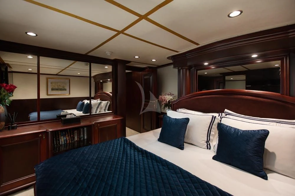 a bedroom with a bed and a desk aboard KALIZMA Yacht for Sale