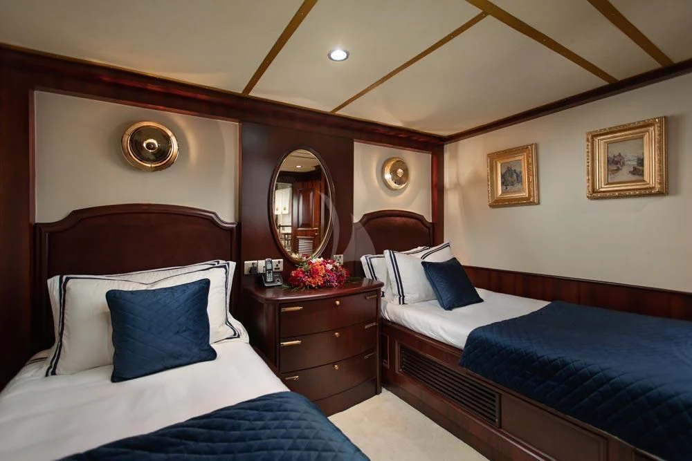 a bedroom with two beds aboard KALIZMA Yacht for Sale