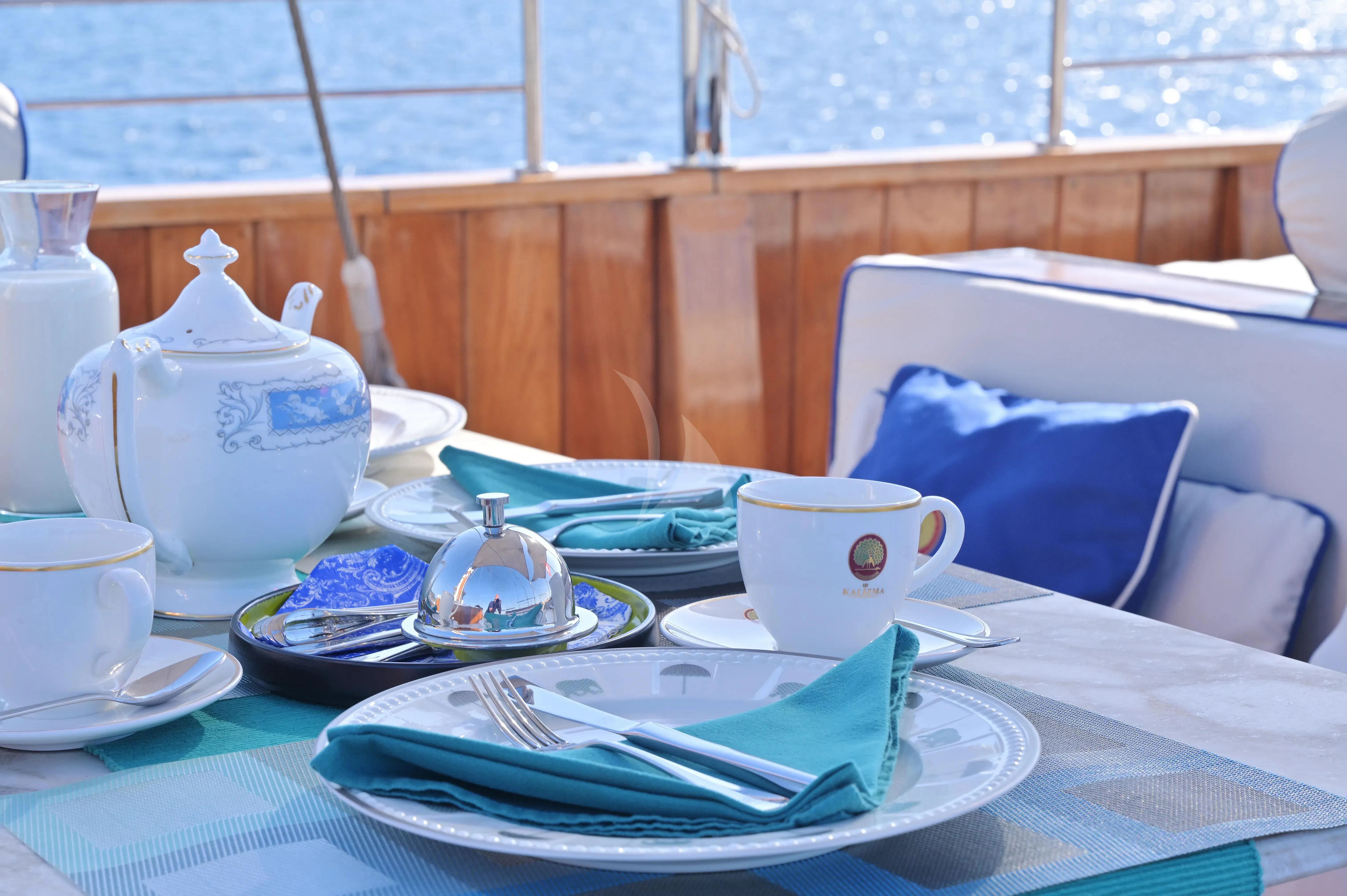 a table with plates and cups on it aboard KALIZMA Yacht for Sale