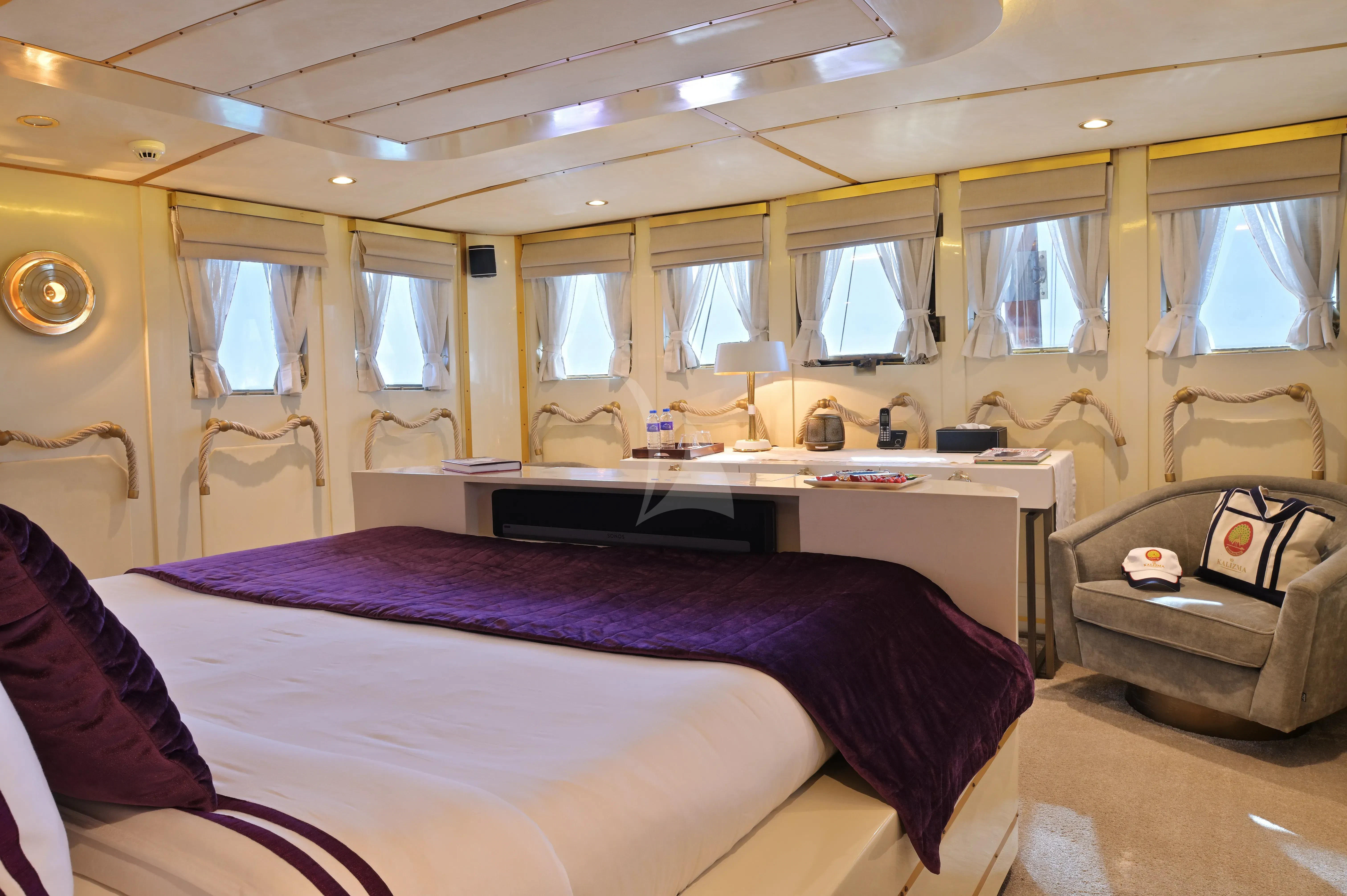 a bedroom with a bed and a couch aboard KALIZMA Yacht for Sale