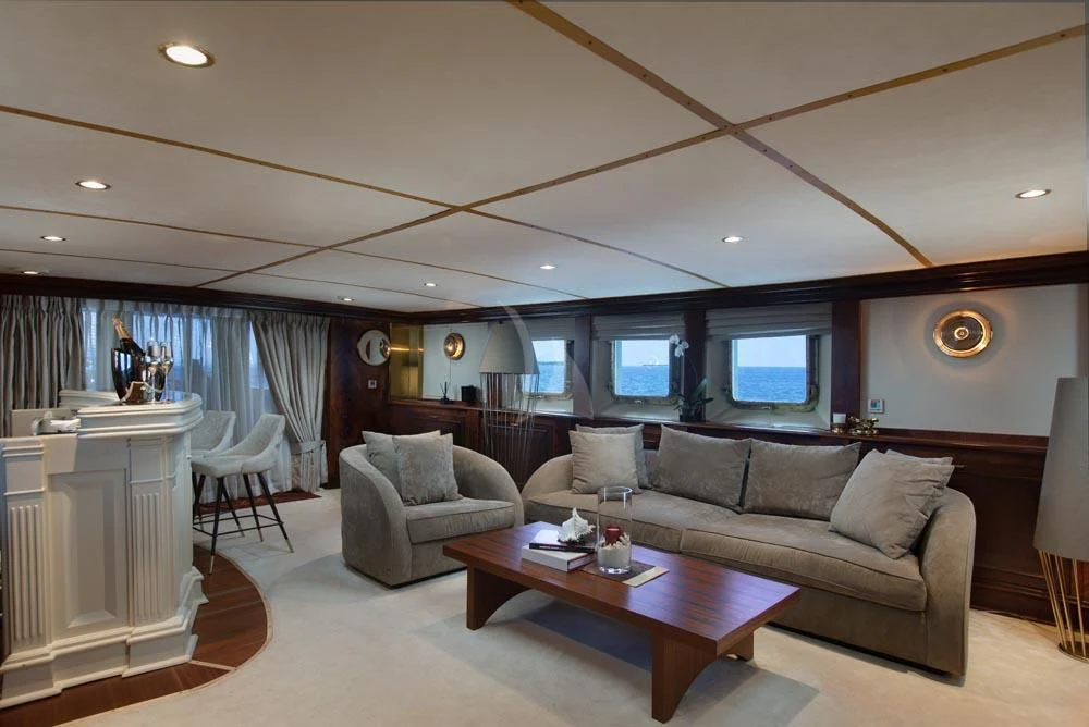 a living room with a couch and a coffee table aboard KALIZMA Yacht for Sale