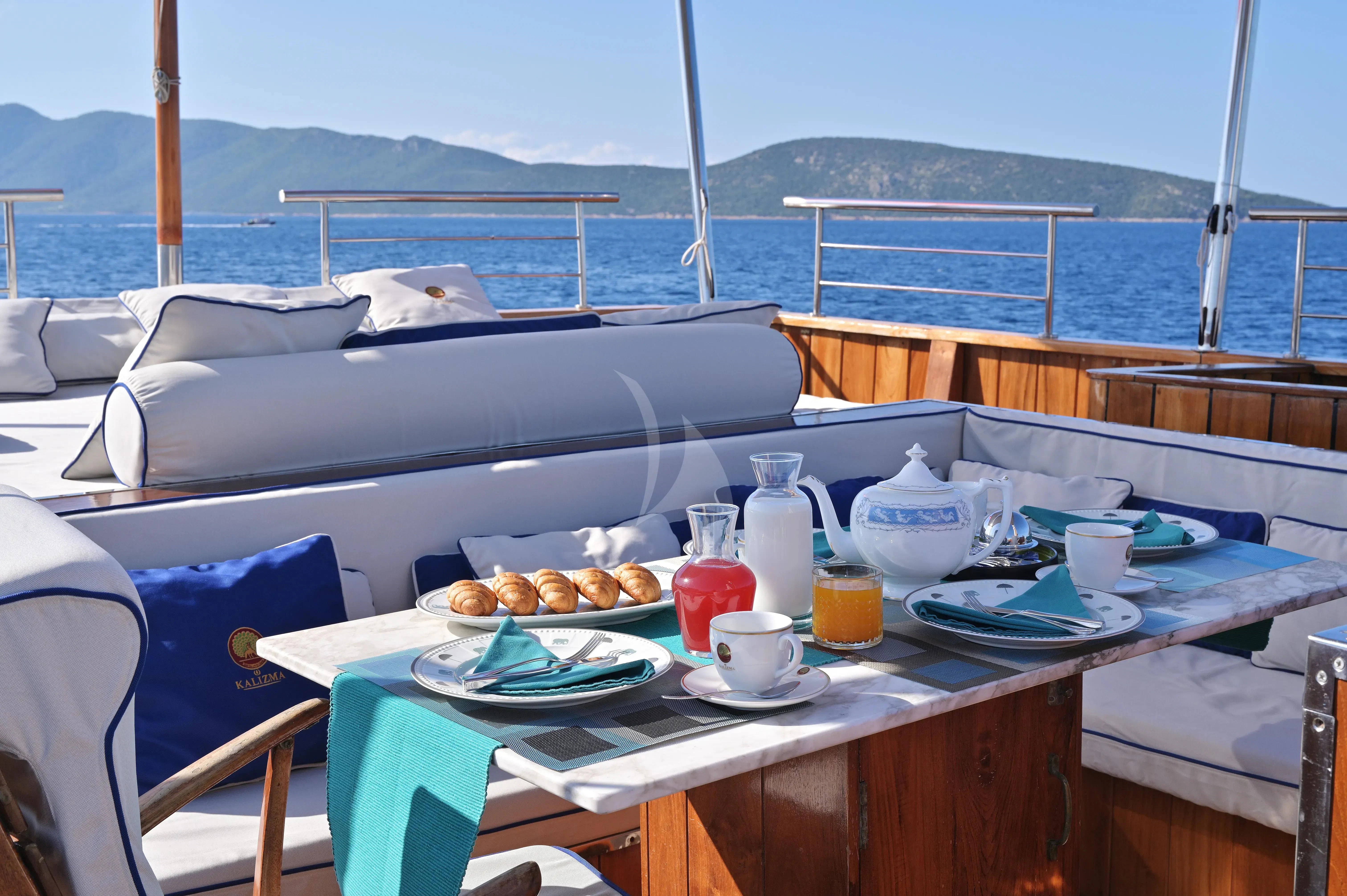 a table with food and drinks on it aboard KALIZMA Yacht for Sale