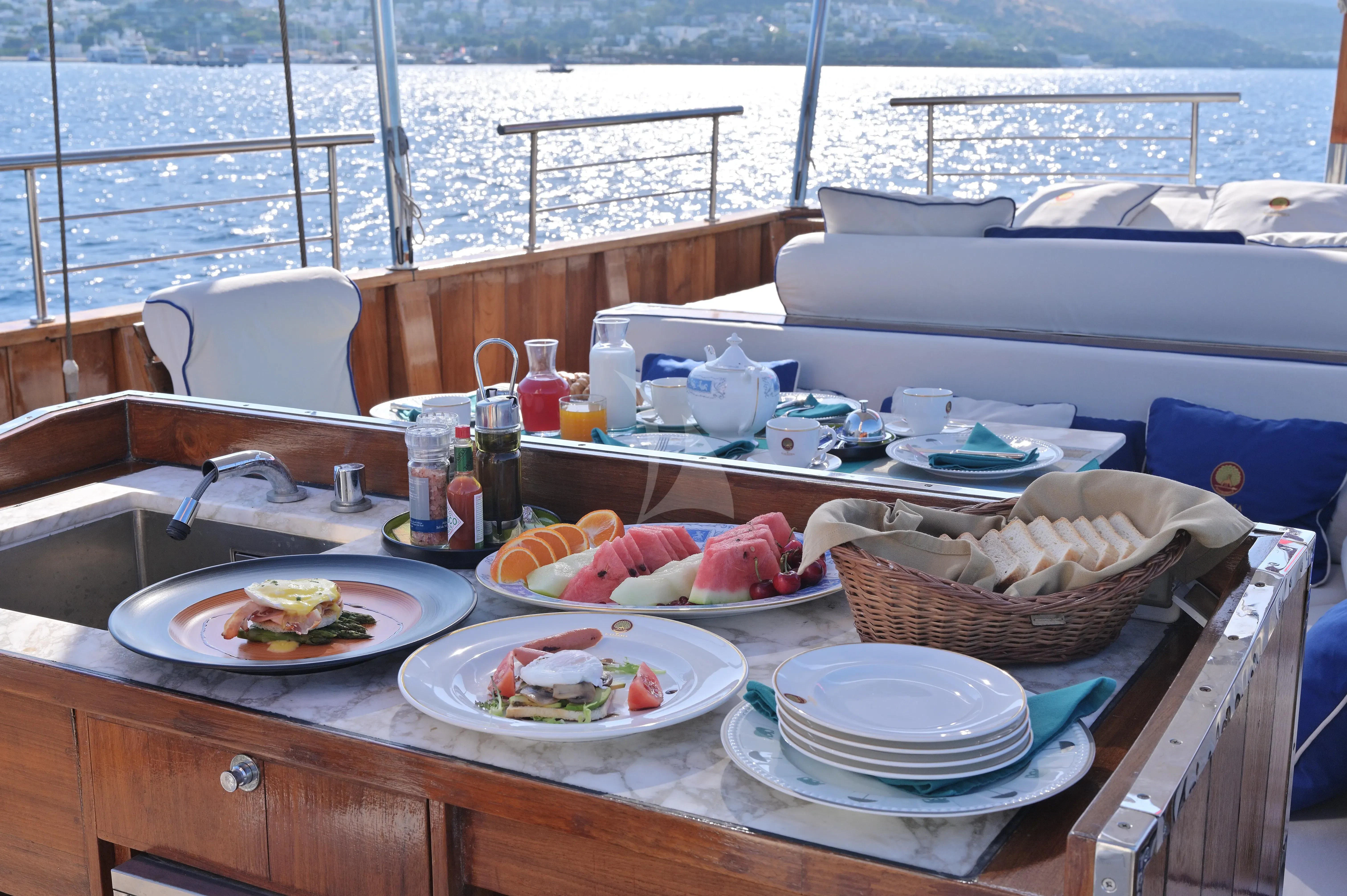 a table with plates and food on it aboard KALIZMA Yacht for Sale