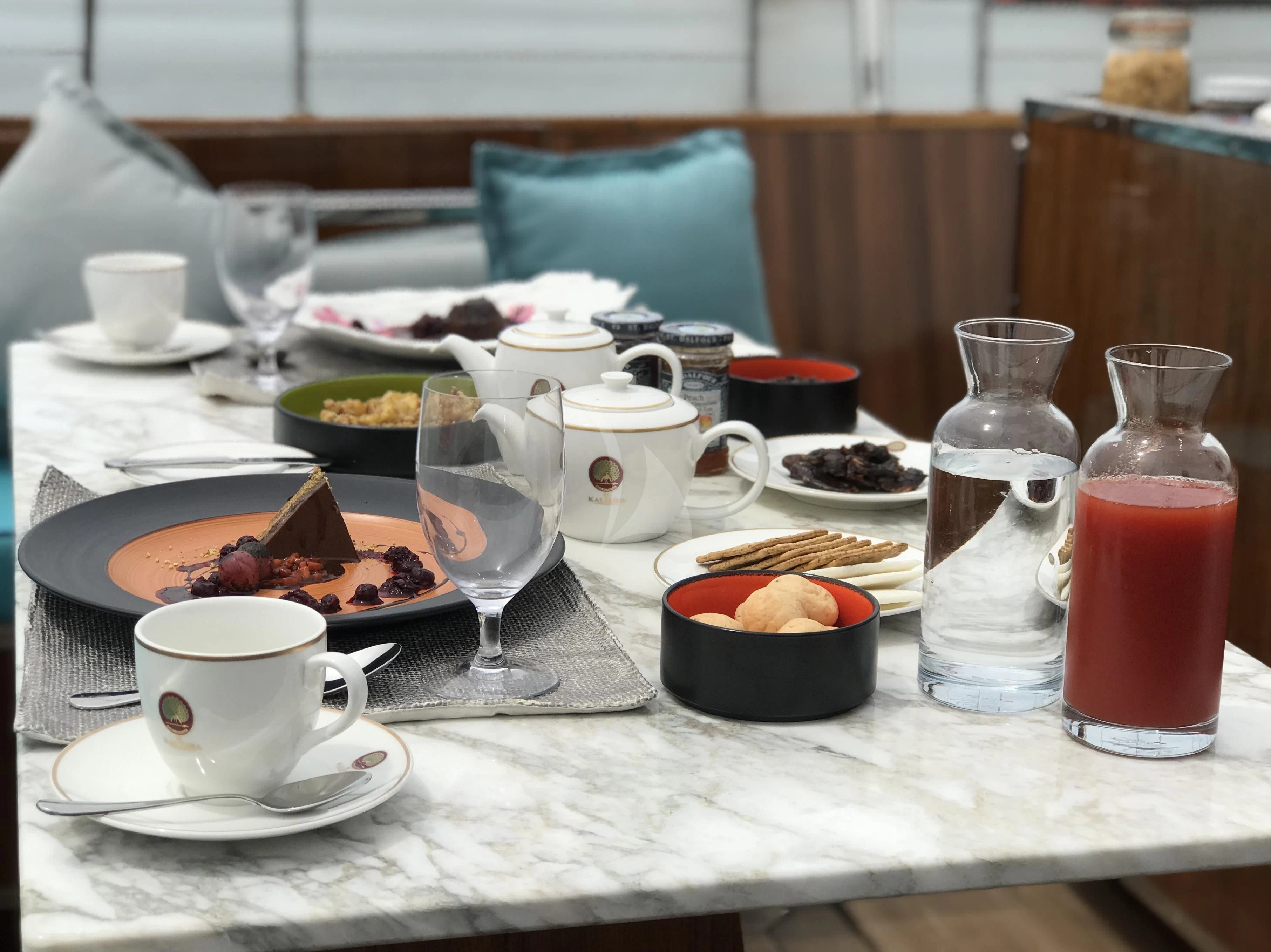 a table with food and drinks on it aboard KALIZMA Yacht for Sale