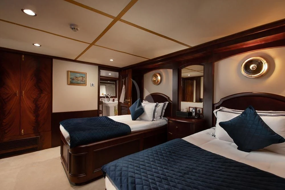 a bedroom with two beds aboard KALIZMA Yacht for Sale