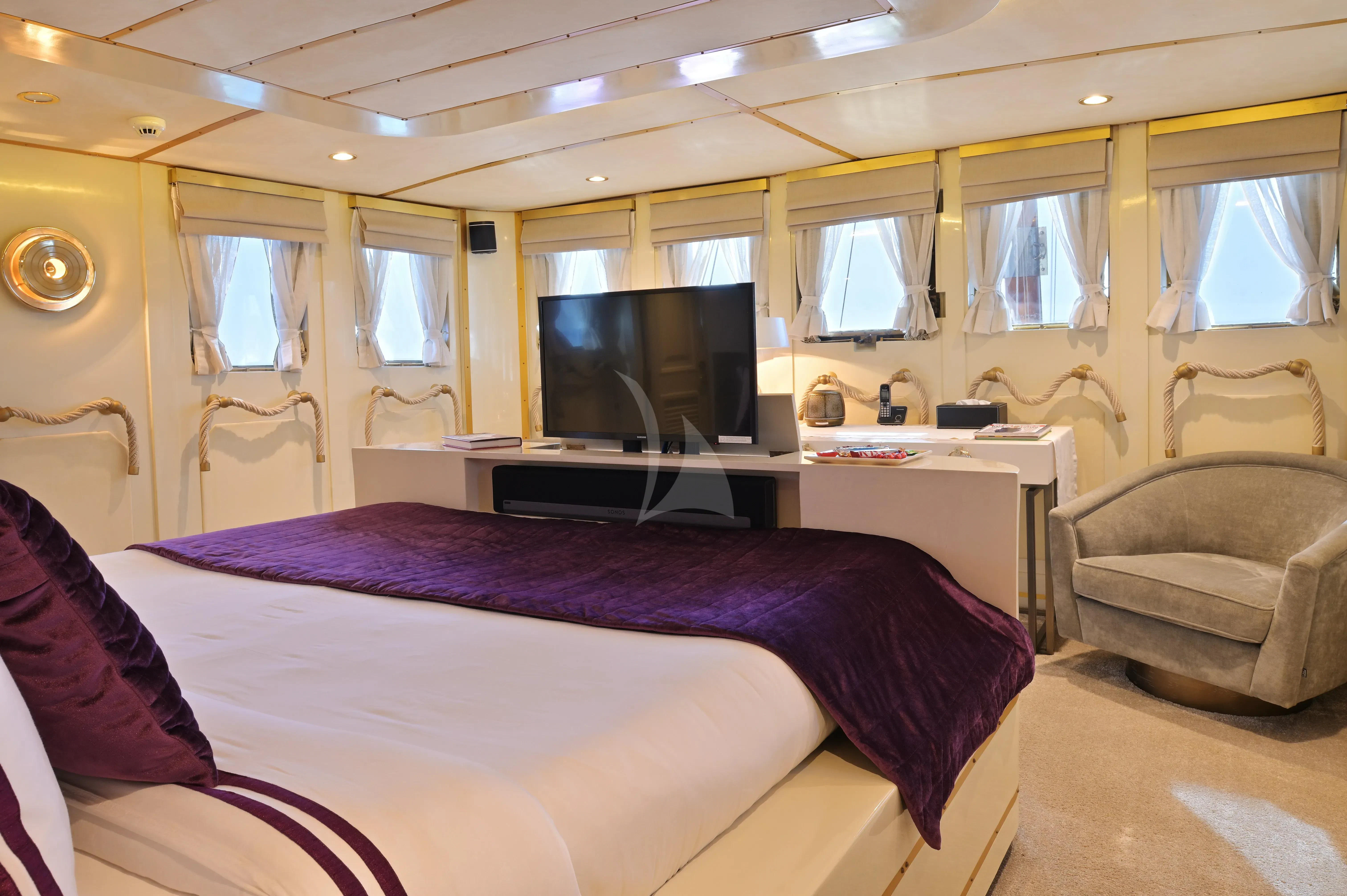 a bedroom with a bed and a tv aboard KALIZMA Yacht for Sale