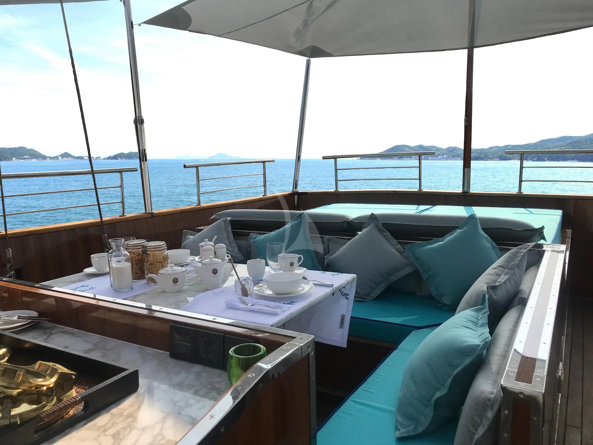 a table with cups and food on it aboard KALIZMA Yacht for Sale