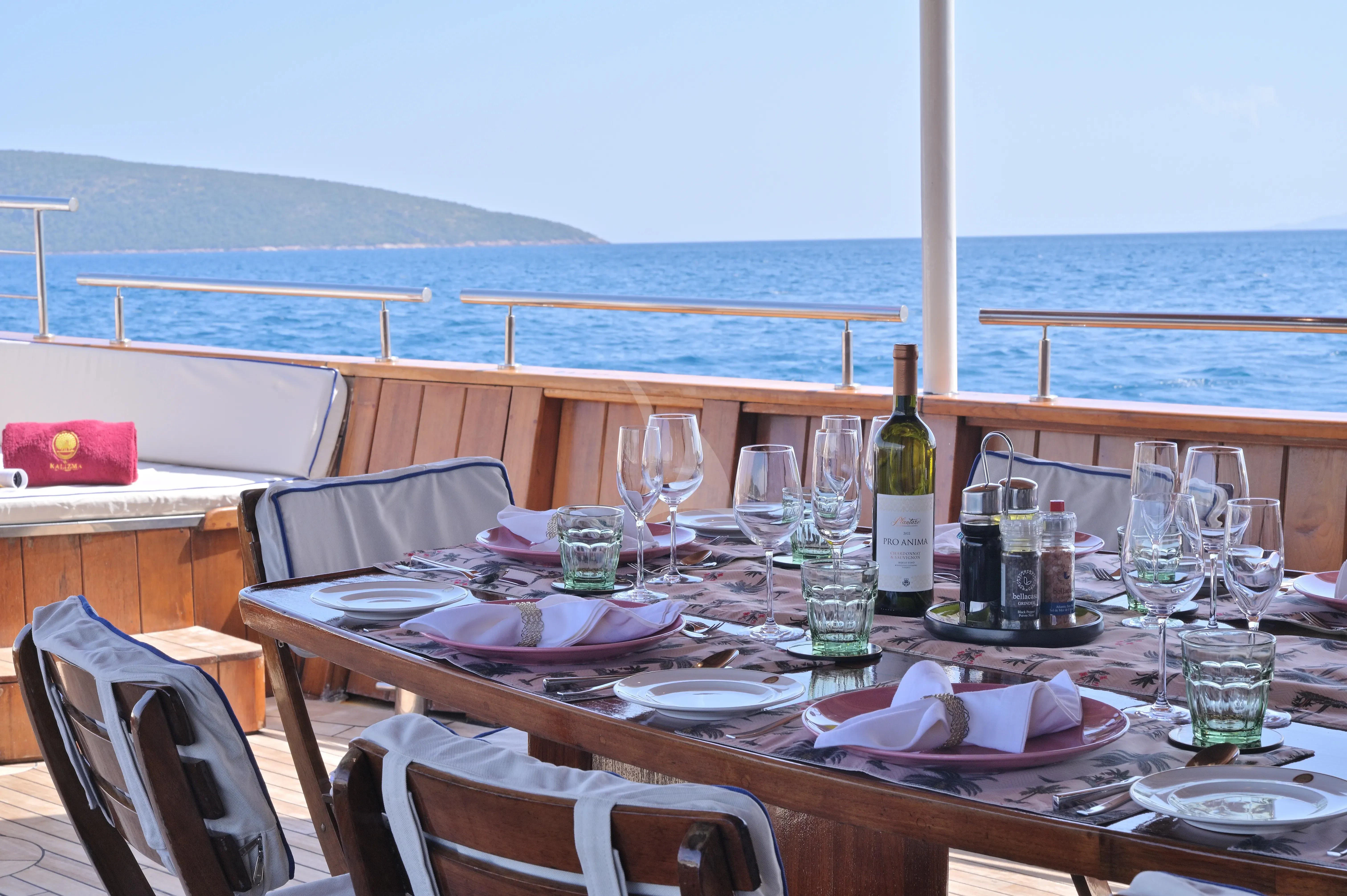 a table with plates and glasses on it aboard KALIZMA Yacht for Sale