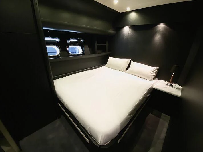 a bed with a white sheet aboard SEA SQUIRTER Yacht for Sale