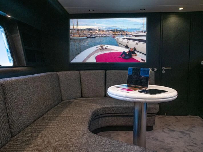 a couch with a laptop on it aboard SEA SQUIRTER Yacht for Sale