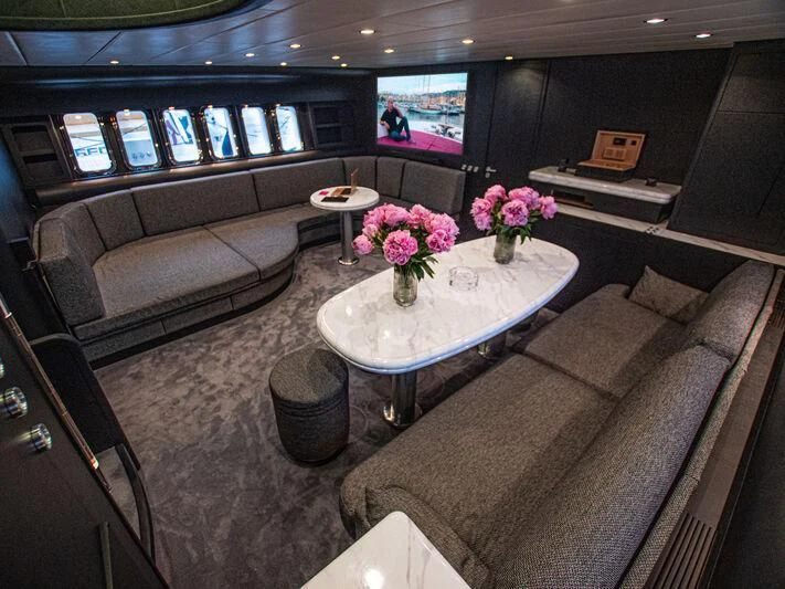 a living room with a couch and a coffee table aboard SEA SQUIRTER Yacht for Sale