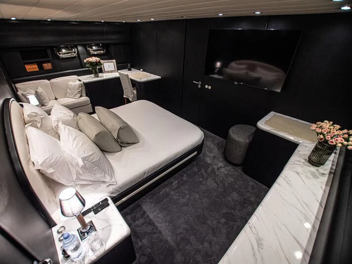 a room with a bed and a couch aboard SEA SQUIRTER Yacht for Sale