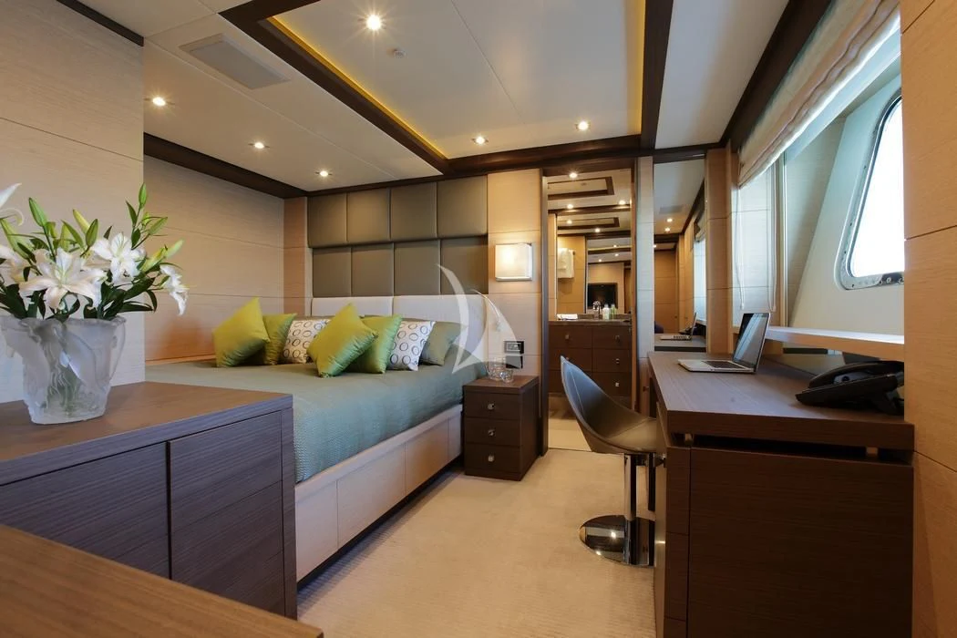 a bedroom with a bed desk and a laptop aboard LATIKO Yacht for Charter
