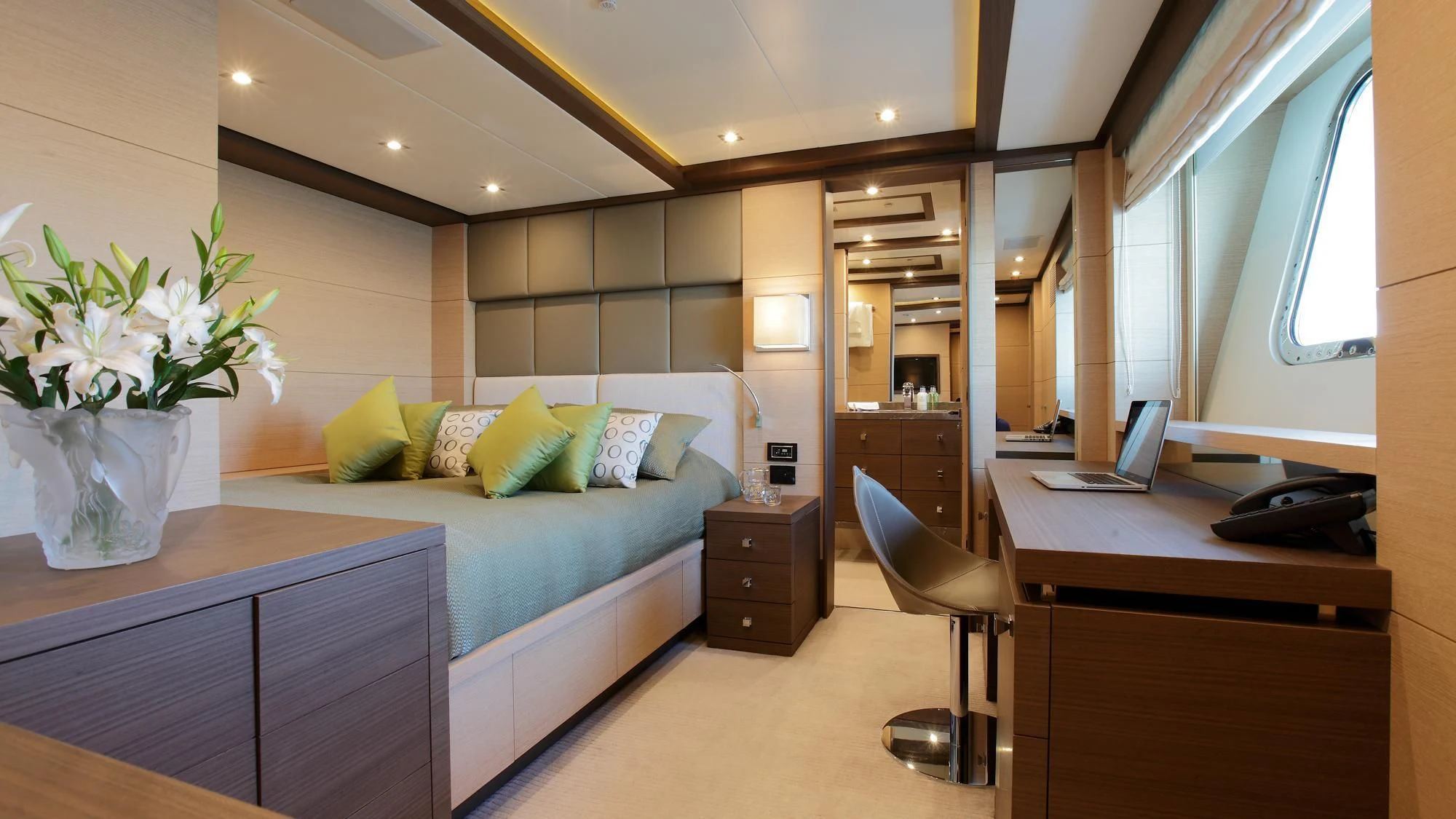 a room with a bed desk and a chair aboard LATIKO Yacht for Charter