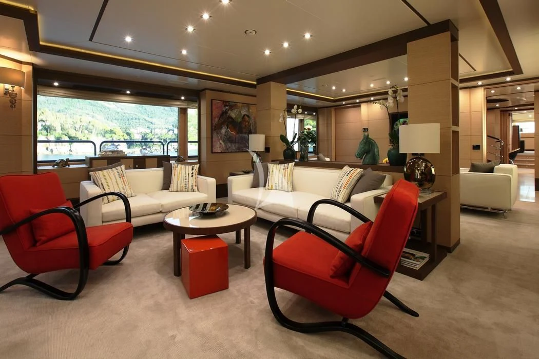 a living room with a red chair and a red chair aboard LATIKO Yacht for Charter