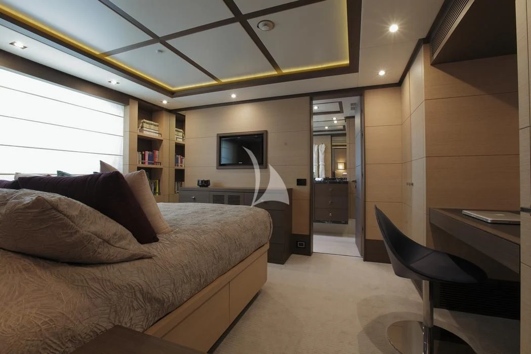 a bedroom with a bed and a desk aboard LATIKO Yacht for Charter