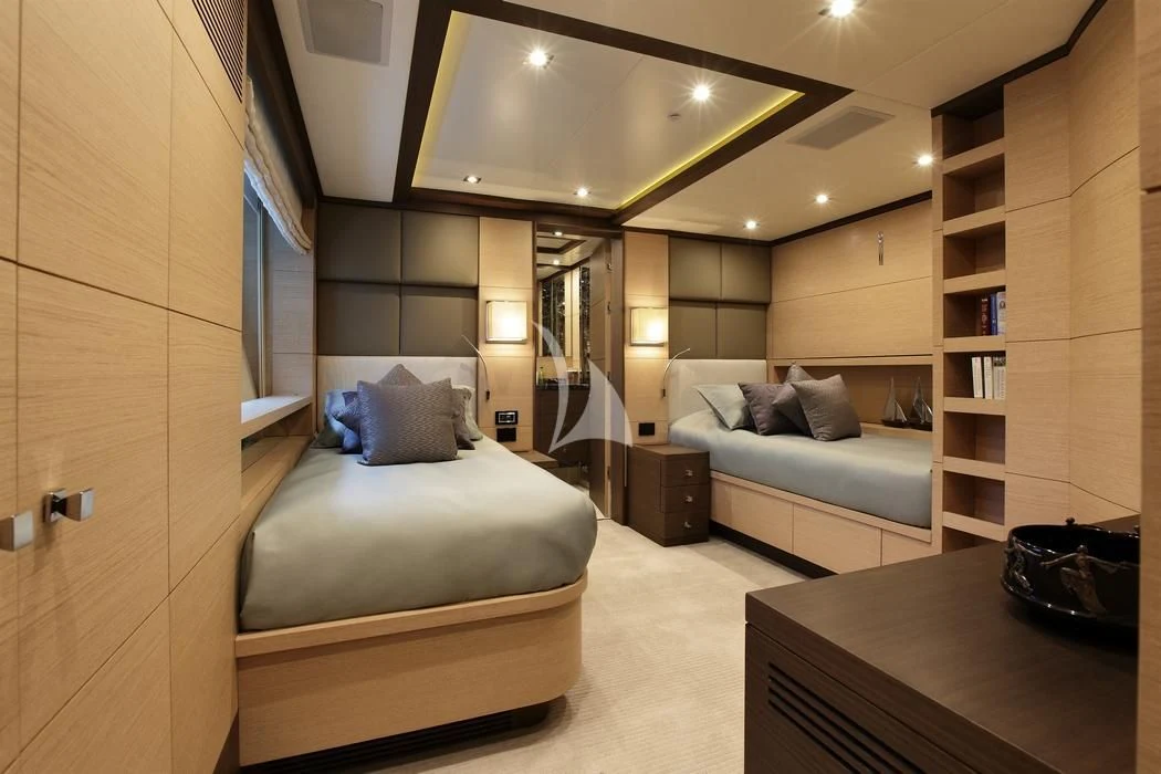 a room with a bed and a bookcase aboard LATIKO Yacht for Charter