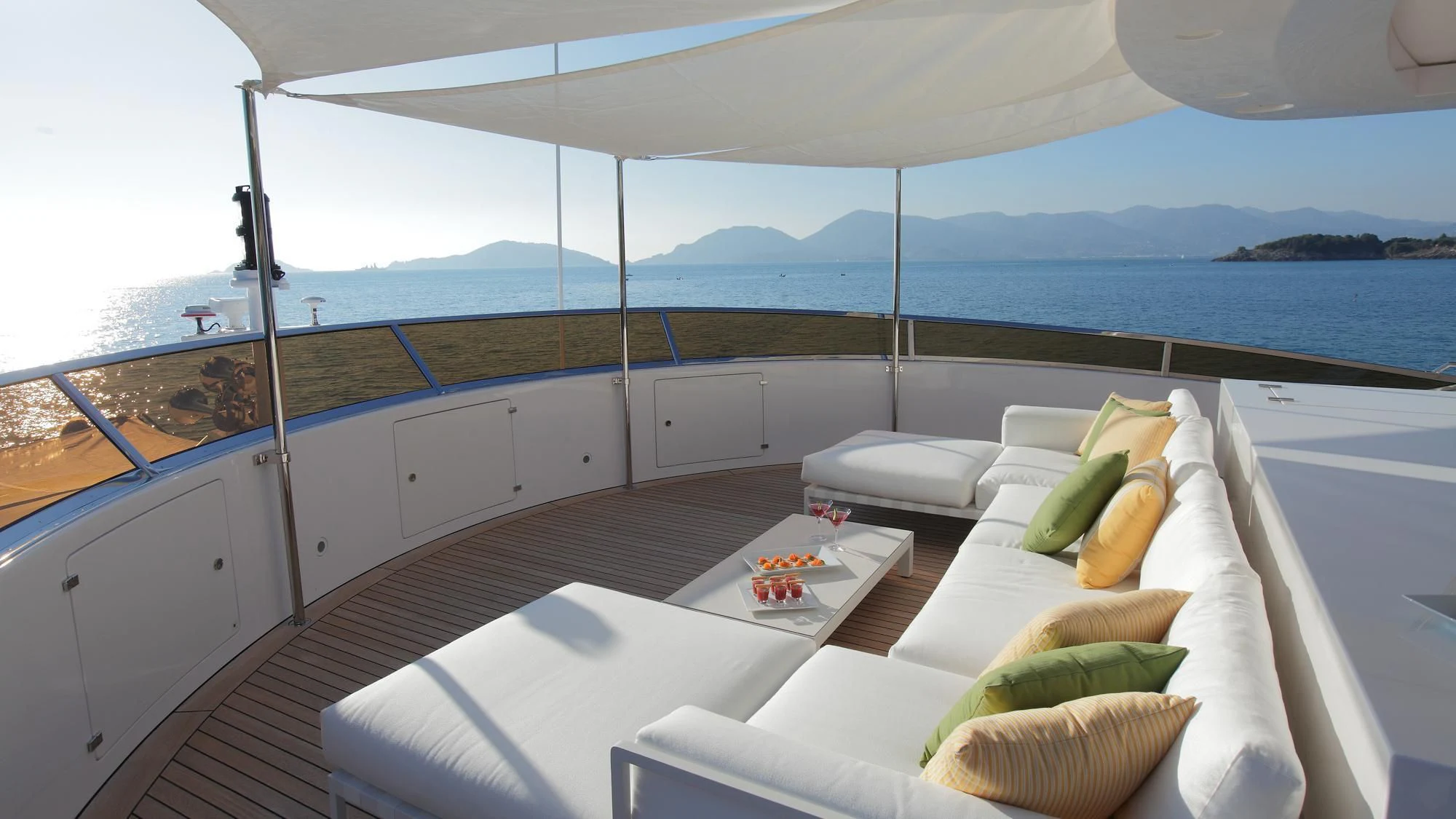 a room with a bed and a table with pillows on it aboard LATIKO Yacht for Charter