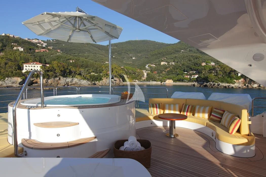 a pool with a table and chairs aboard LATIKO Yacht for Charter