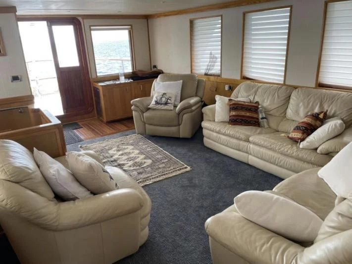 a living room with a couch and a coffee table aboard ATLANTIC LADY Yacht for Sale