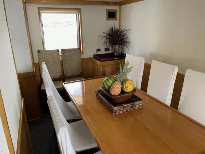 a table with chairs and fruit on it aboard ATLANTIC LADY Yacht for Sale