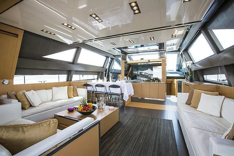 a room with a couch and a table and chairs aboard WHATEVER Yacht for Charter