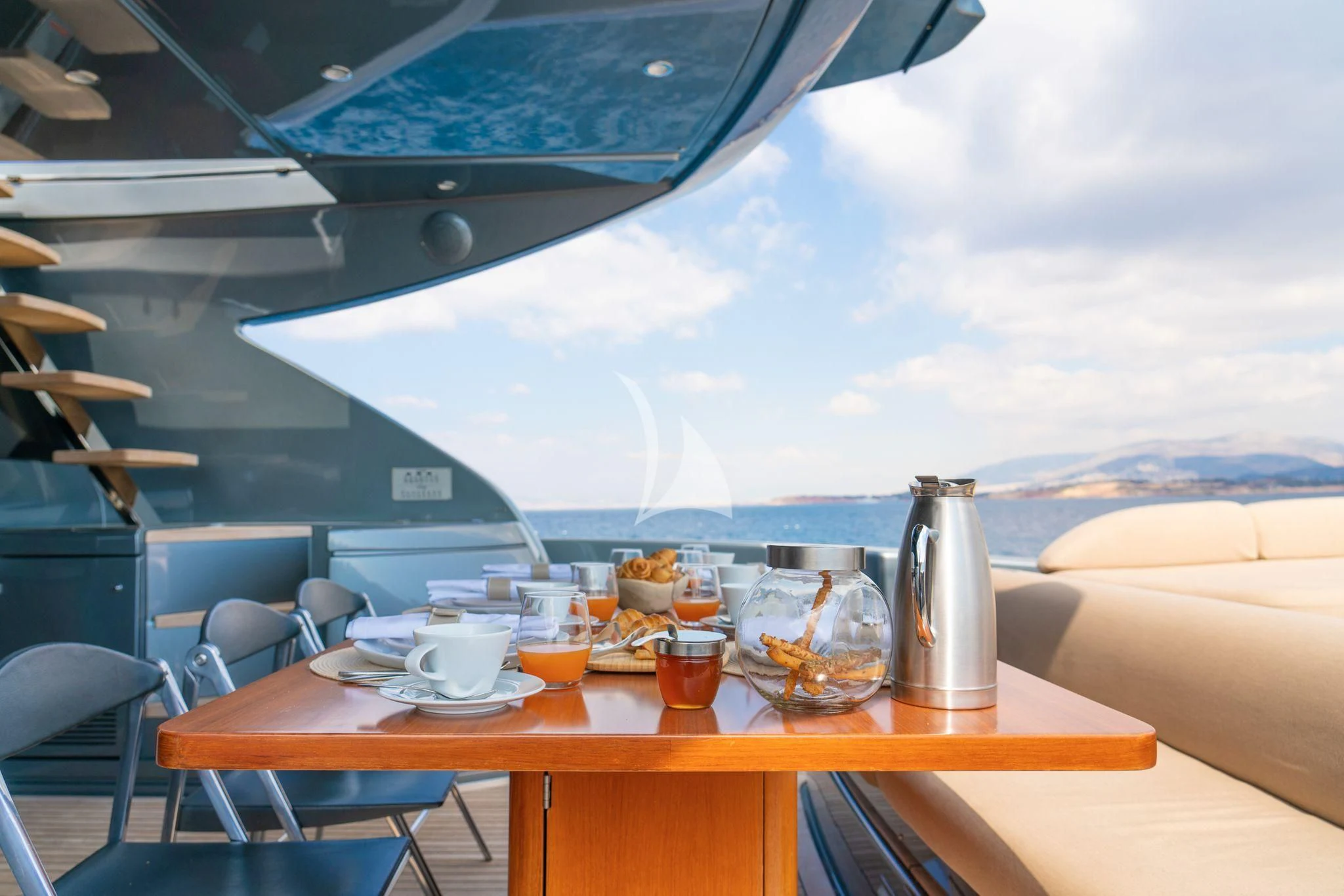 a table with food and drinks on it aboard WHATEVER Yacht for Charter