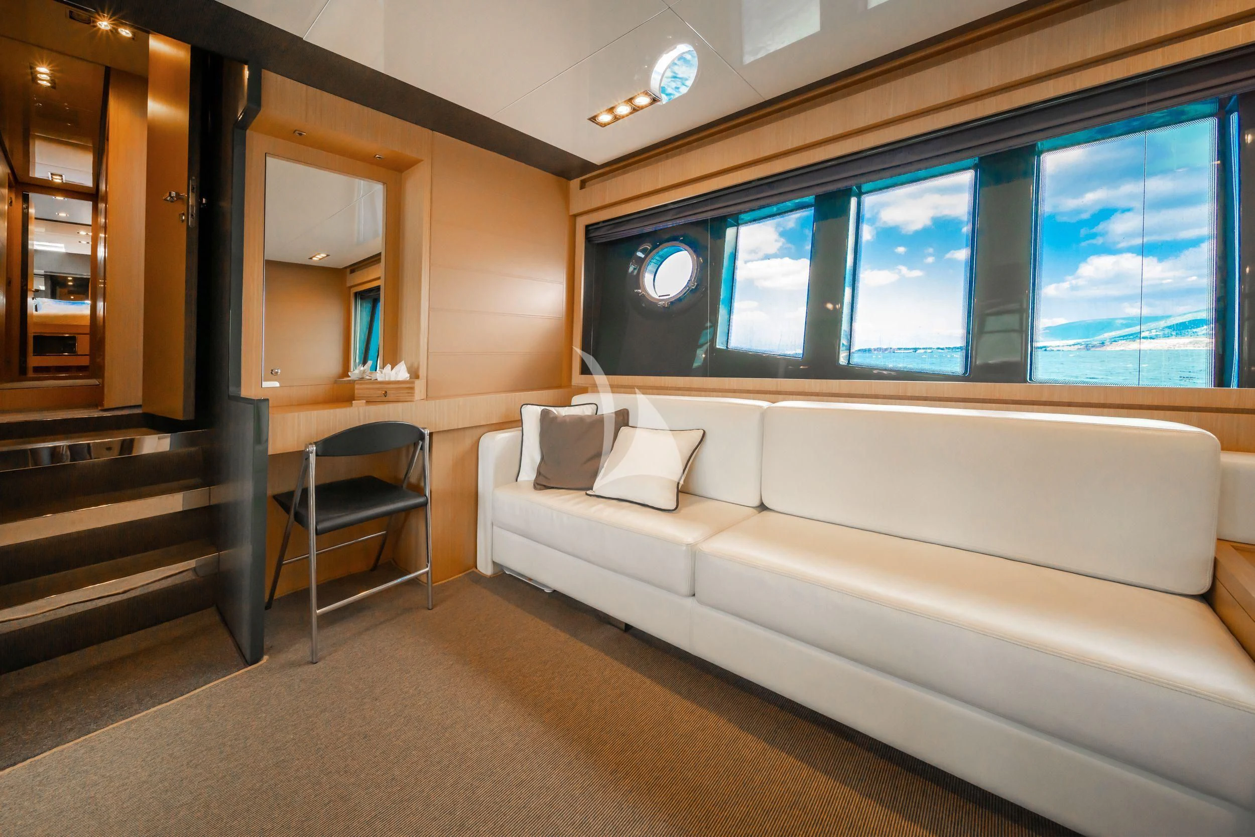 a room with a couch and a window aboard WHATEVER Yacht for Charter