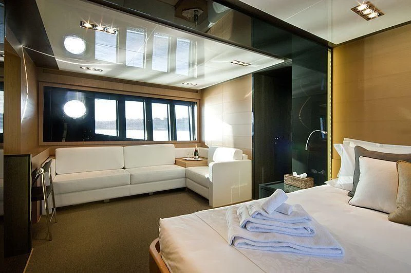 a room with a bed and a couch aboard WHATEVER Yacht for Charter