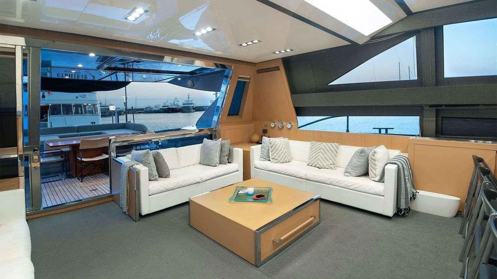 a living room with a couch and a table aboard WHATEVER Yacht for Charter