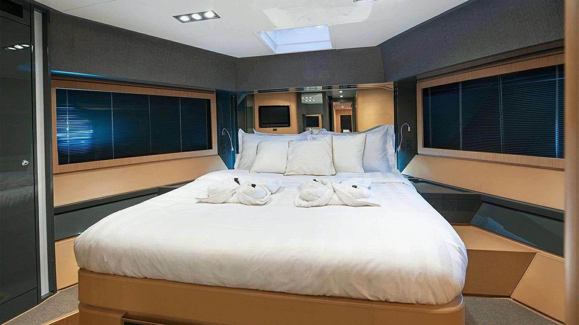 a bed with white sheets aboard WHATEVER Yacht for Charter