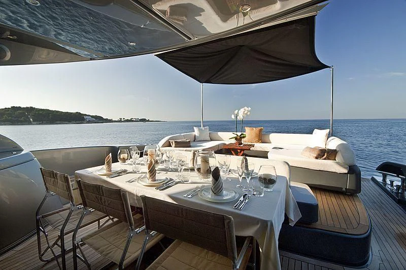 a table set for a meal on a boat aboard WHATEVER Yacht for Charter