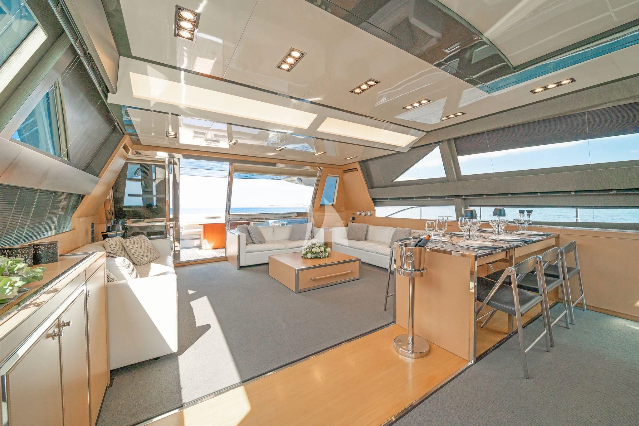 a large room with a table and chairs aboard WHATEVER Yacht for Charter