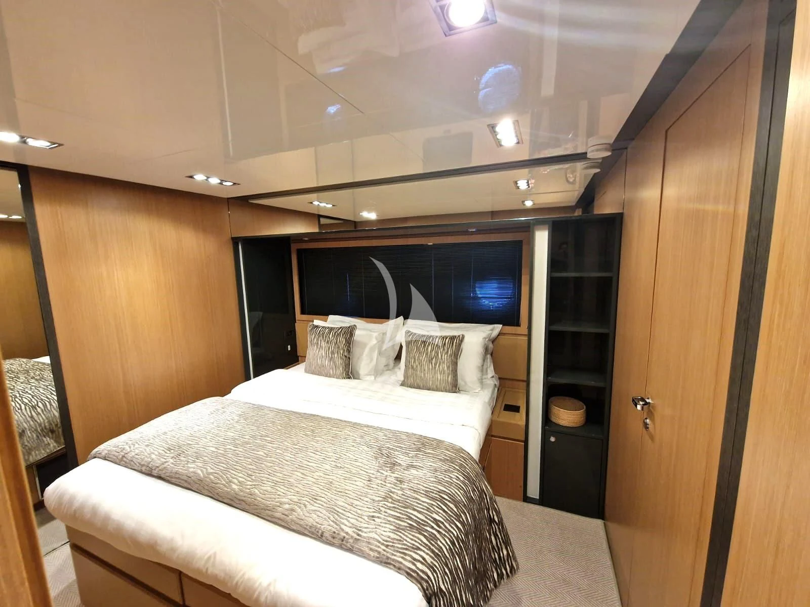 a room with a bed and a cabinet aboard WHATEVER Yacht for Charter