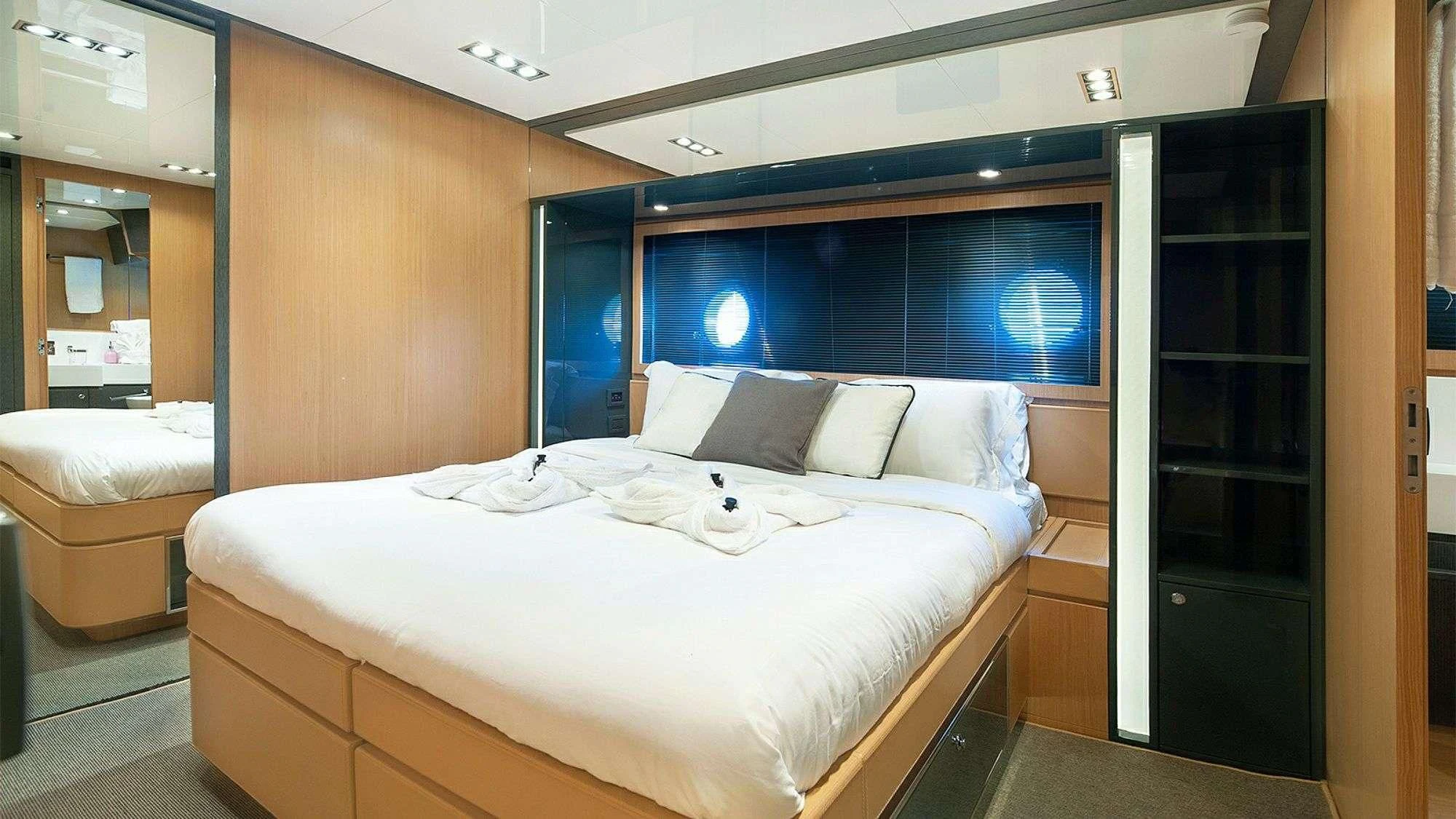 a room with a bed and a closet aboard WHATEVER Yacht for Charter
