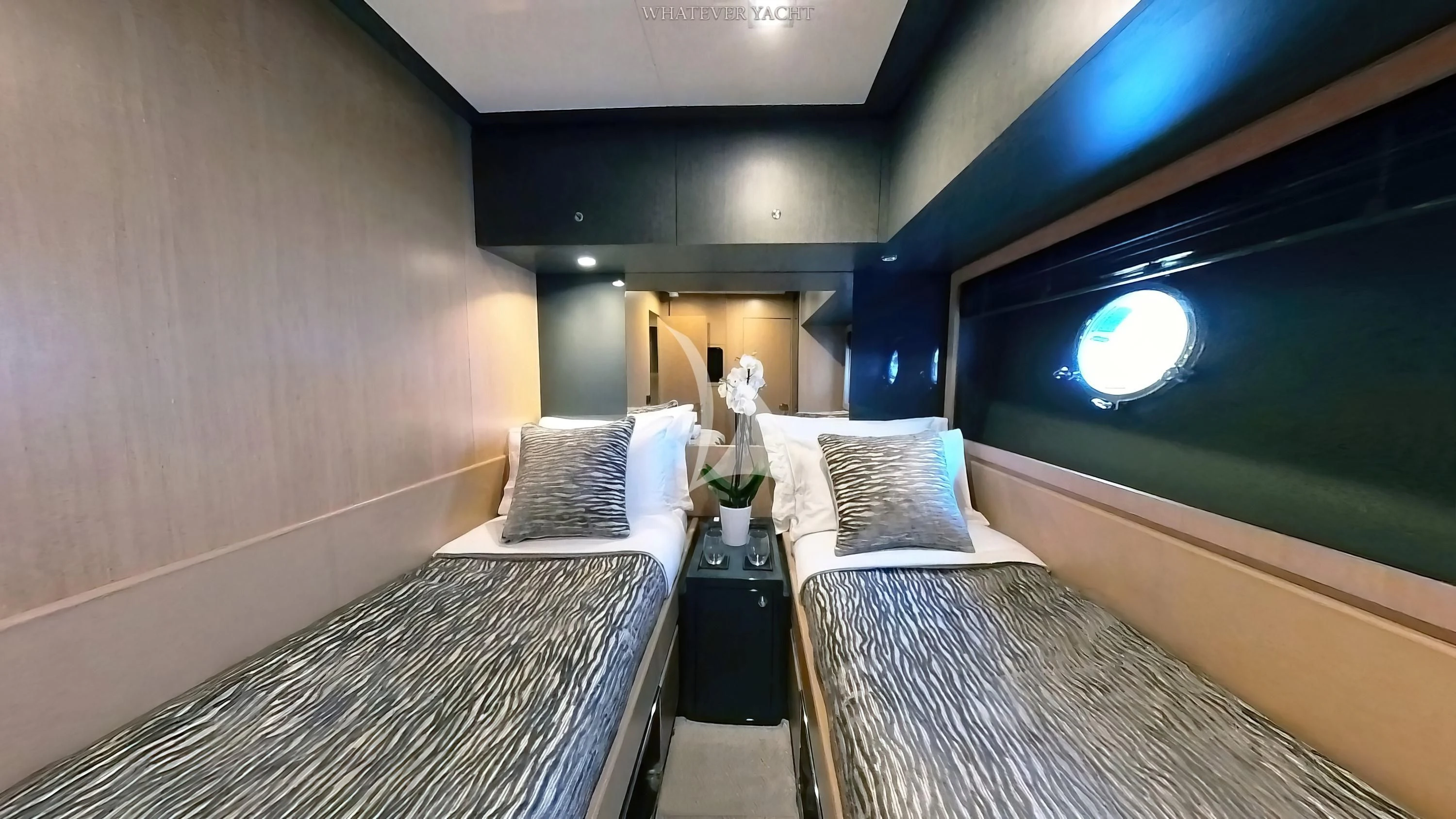 a room with a bed and a plant on the table aboard WHATEVER Yacht for Charter
