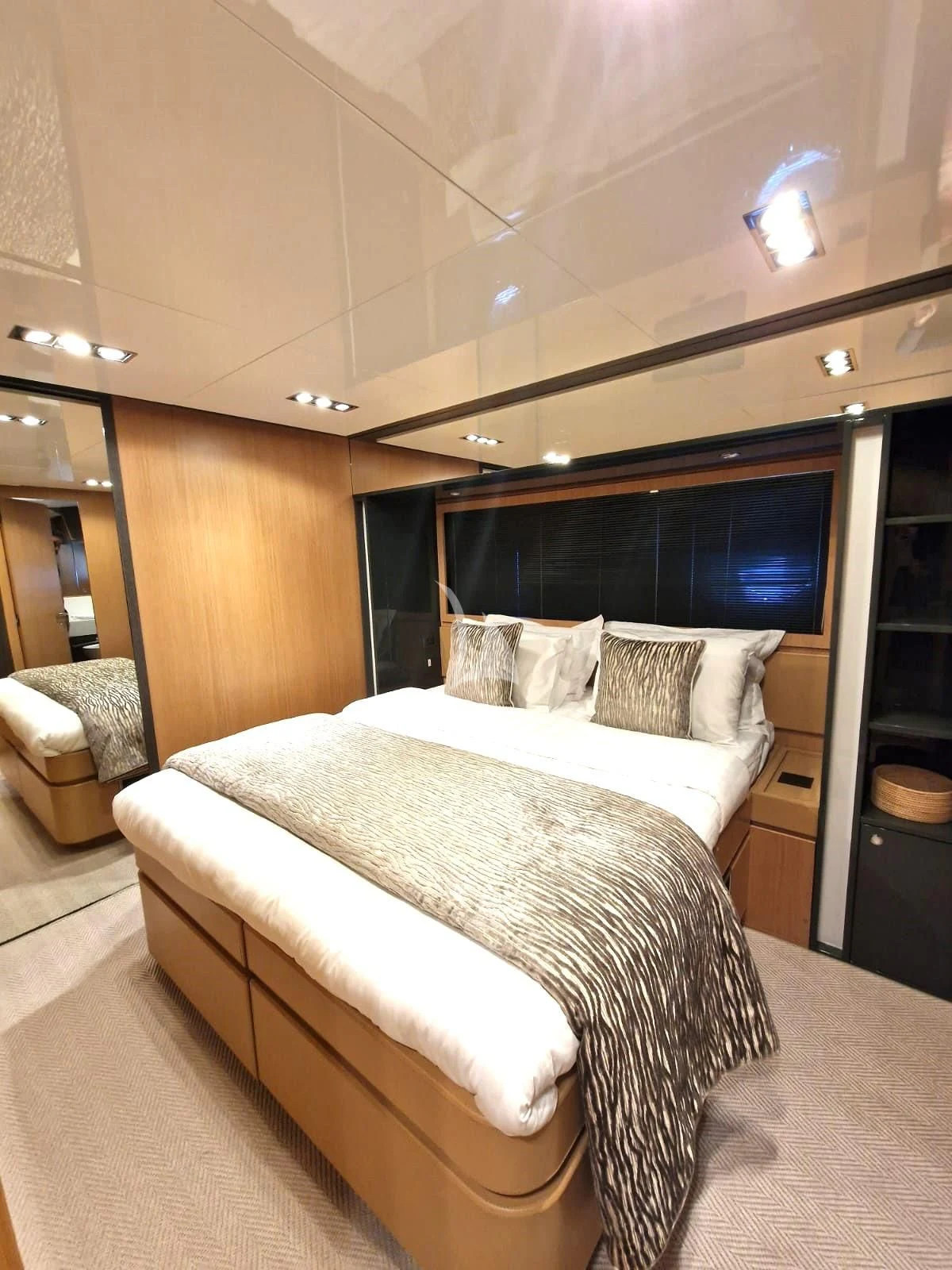 a room with a bed and a chair aboard WHATEVER Yacht for Charter