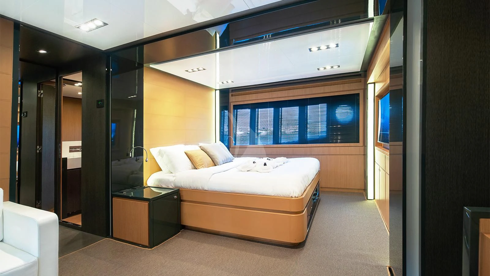 a room with a bed and a desk aboard WHATEVER Yacht for Charter