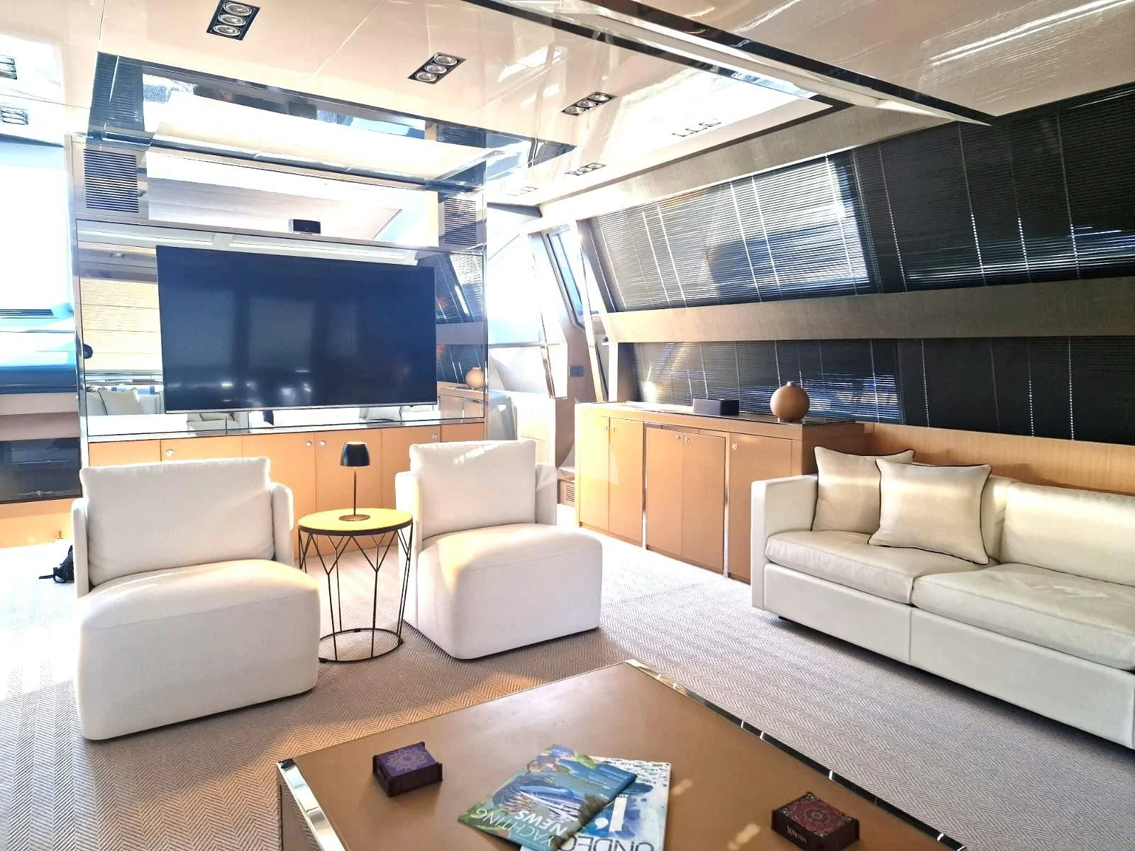 a living room with a large tv aboard WHATEVER Yacht for Charter