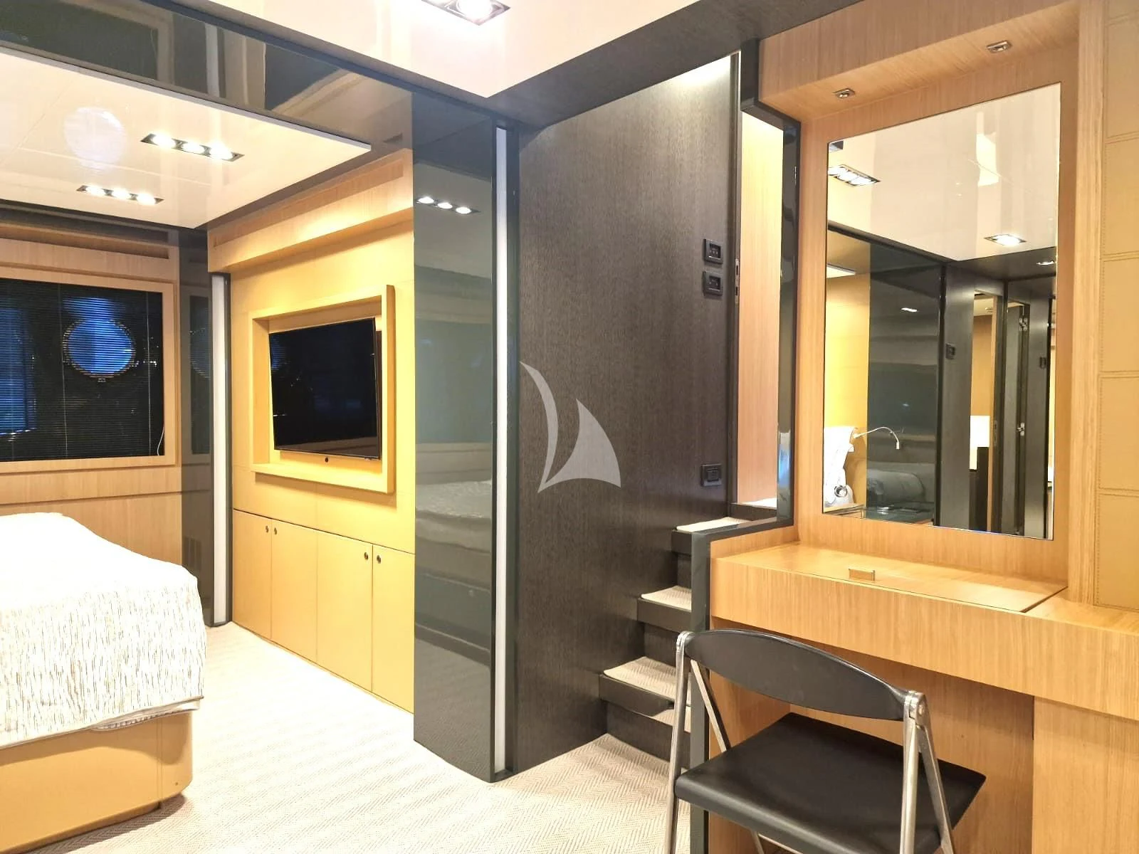 a room with a bed and a desk aboard WHATEVER Yacht for Charter