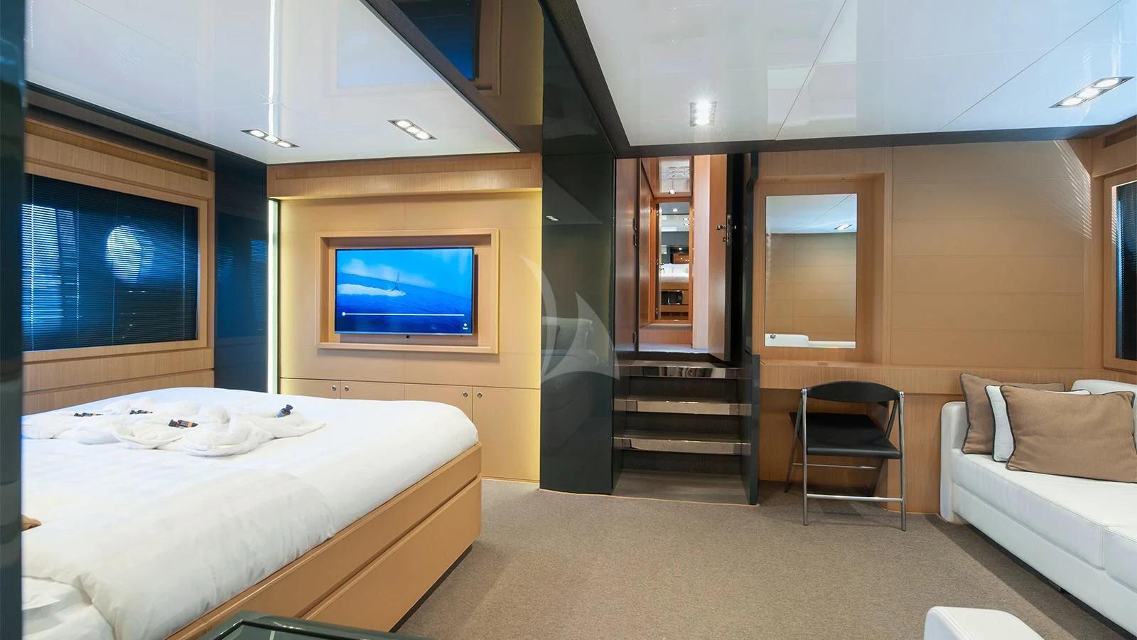 a room with a bed and a tv aboard WHATEVER Yacht for Charter