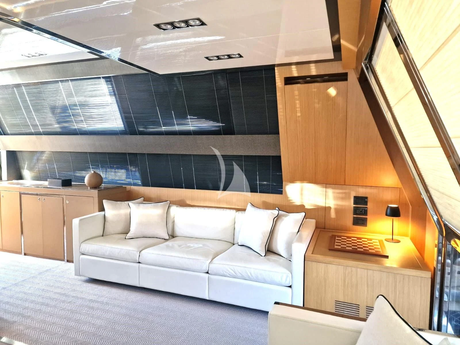 a room with a couch and a large window aboard WHATEVER Yacht for Charter