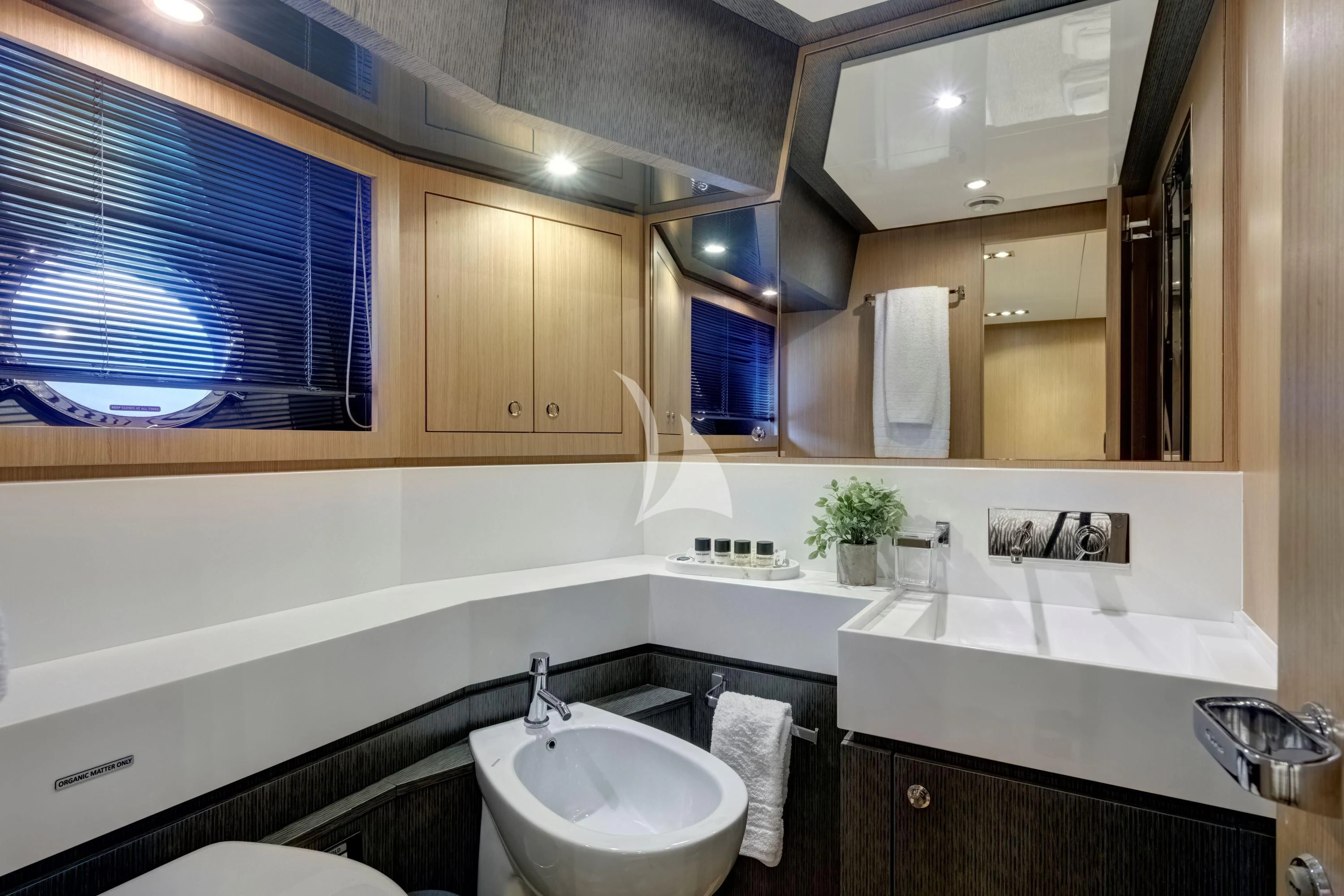 a bathroom with a sink and a mirror aboard WHATEVER Yacht for Charter
