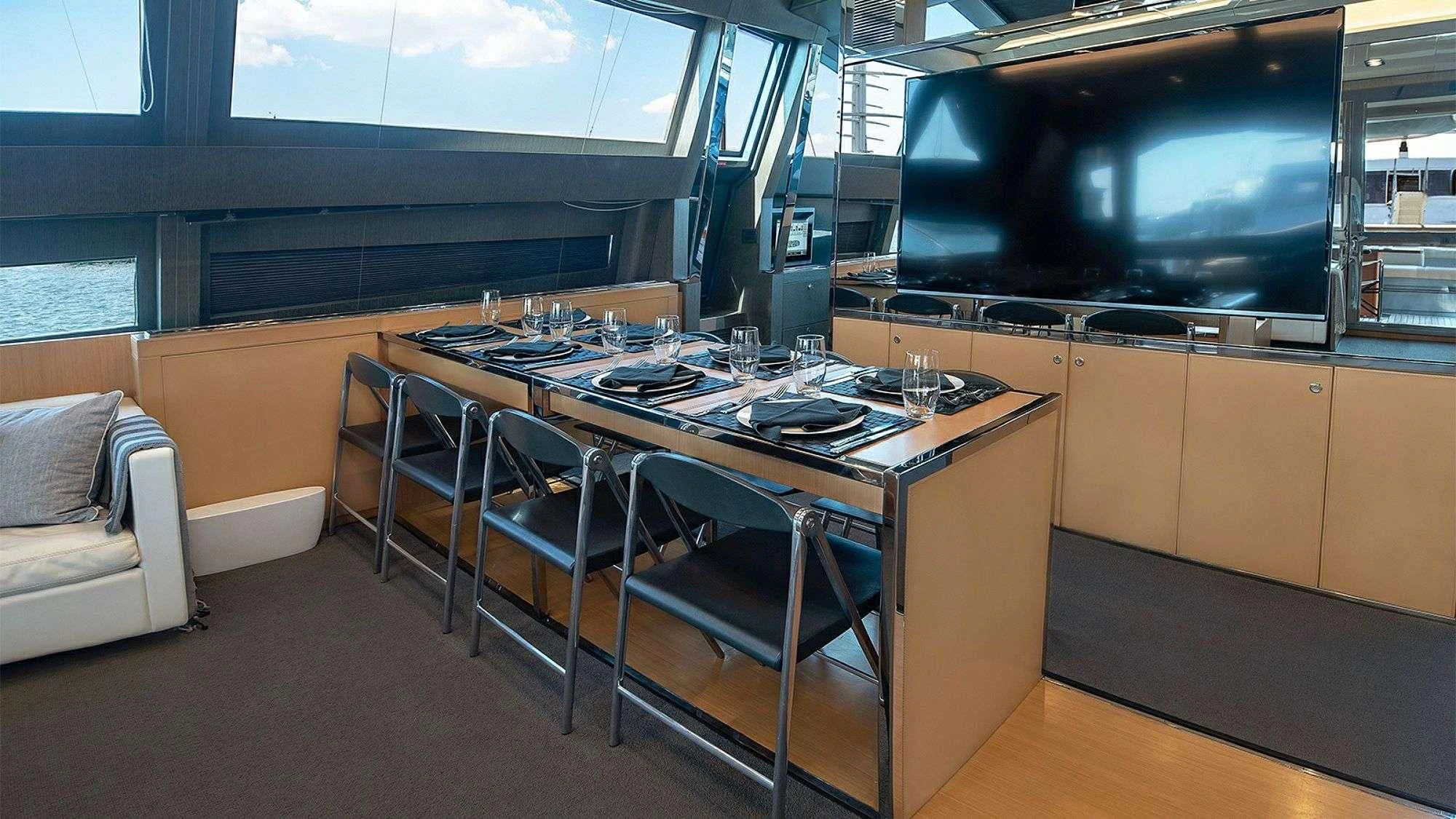 a kitchen with a table and chairs aboard WHATEVER Yacht for Charter