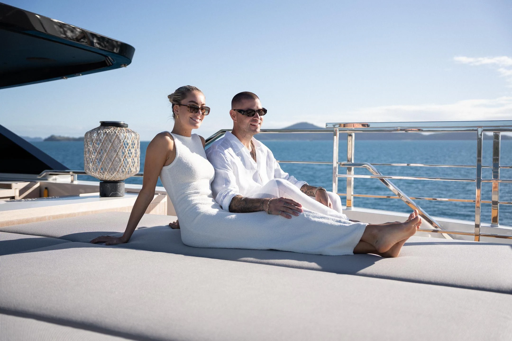 a couple sitting on a boat aboard AIX Yacht for Sale