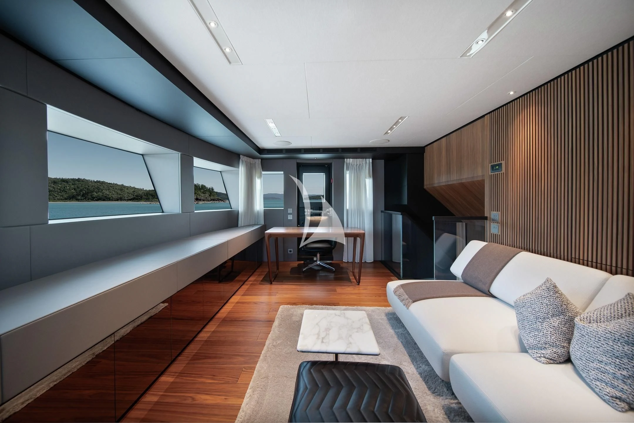 a room with a couch and a table and a window aboard AIX Yacht for Sale