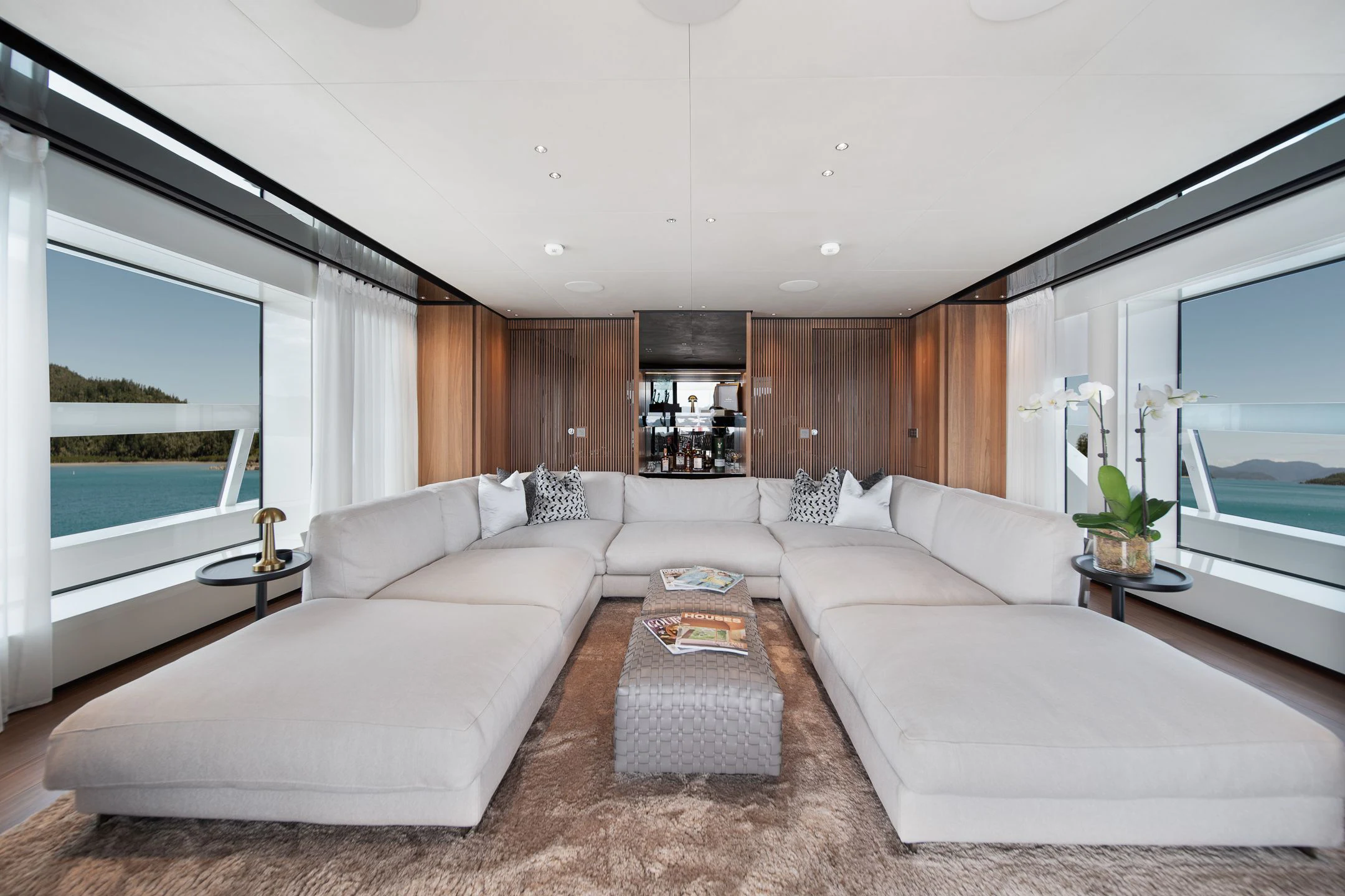 a large living room with a large window aboard AIX Yacht for Sale