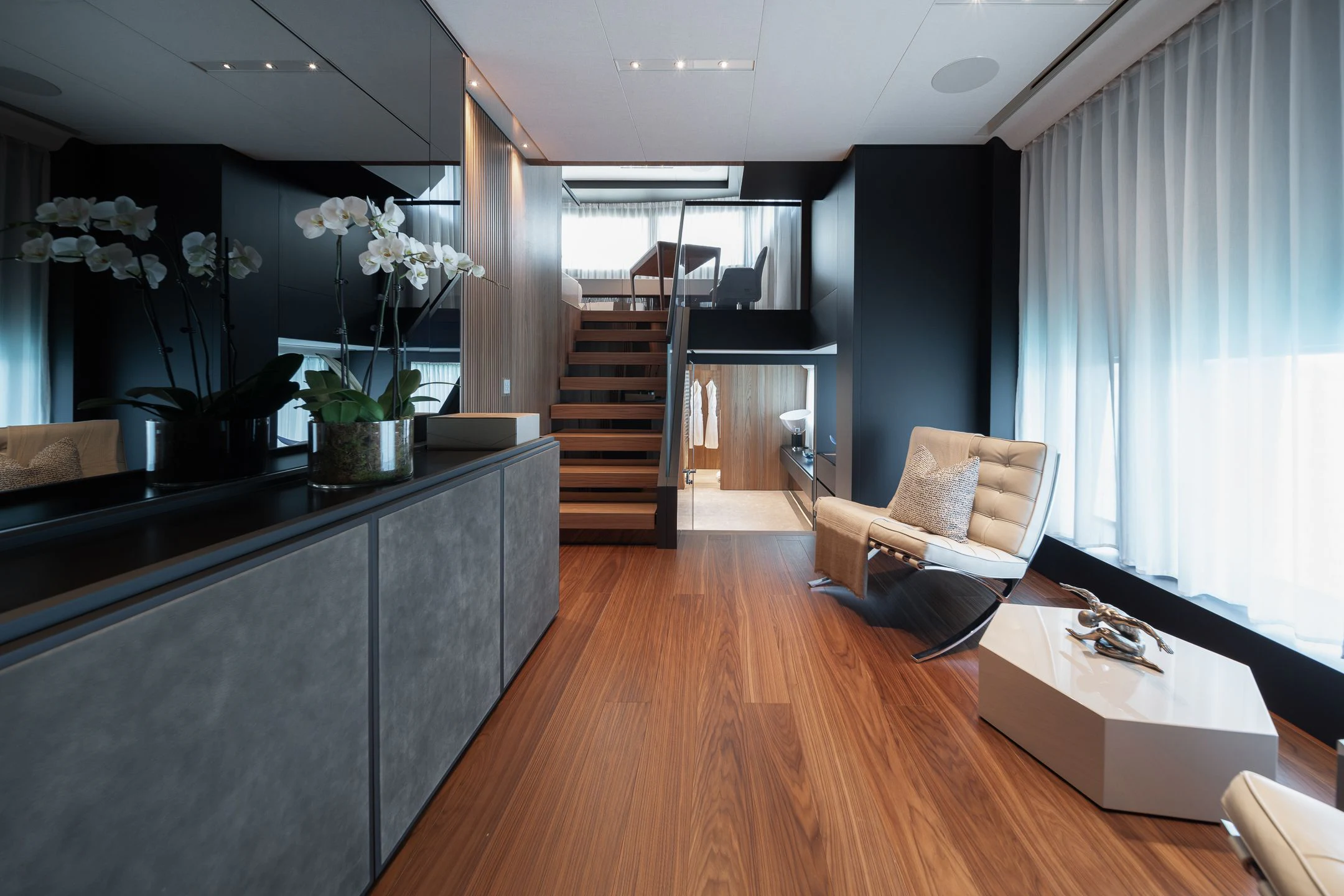 a room with a wood floor and a staircase aboard AIX Yacht for Sale