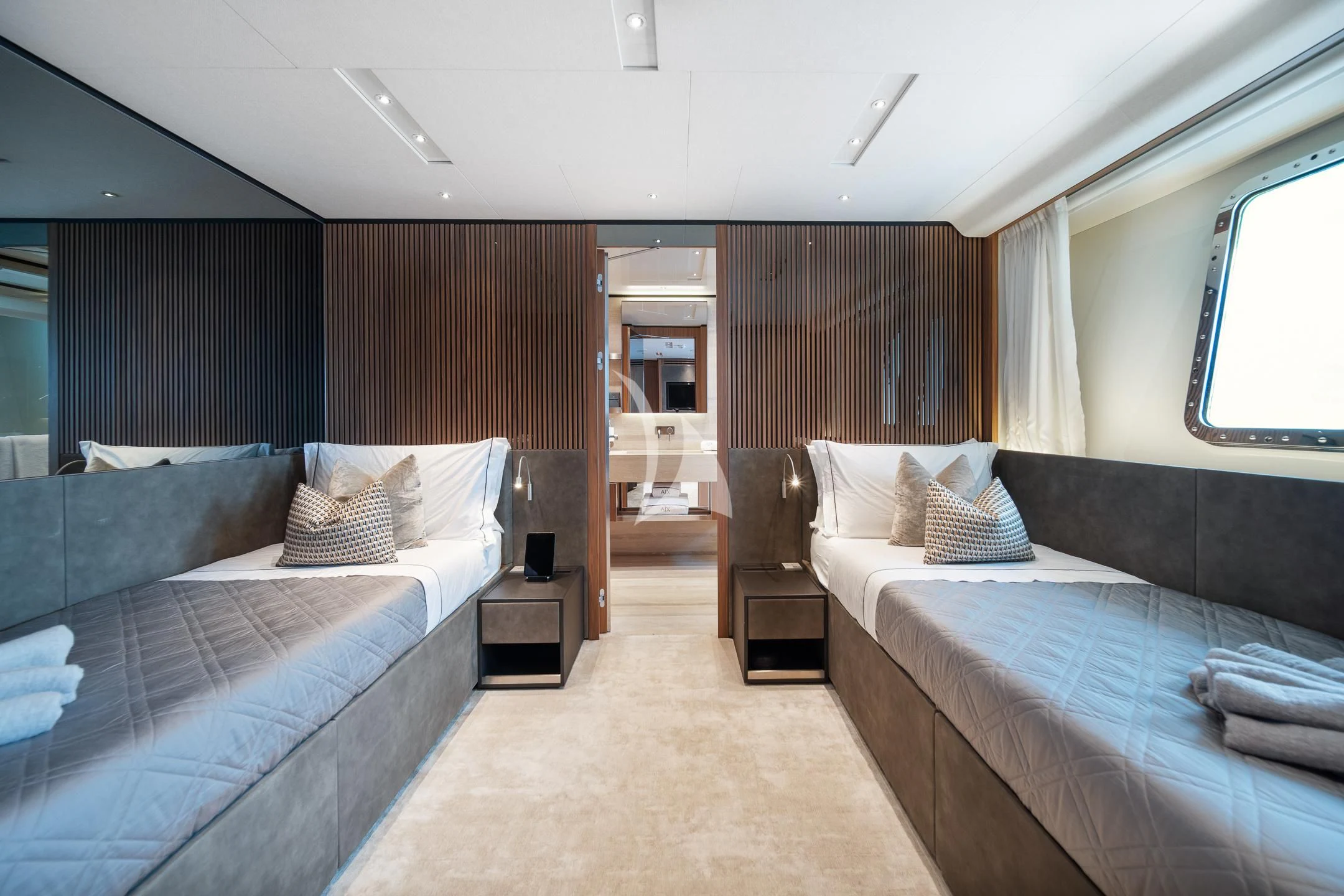 a room with a bed and a chair aboard AIX Yacht for Sale